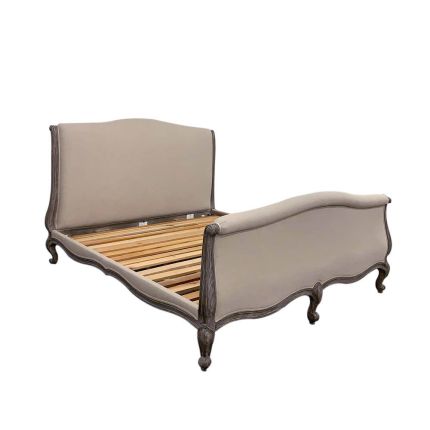 Dreamy french style bed with beige linen upholstery and dark brown wood frame