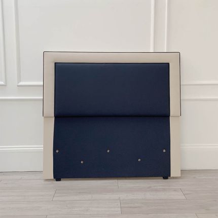 Elegant navy blue leather and grey linen headboard suitable fro a kingsize bed