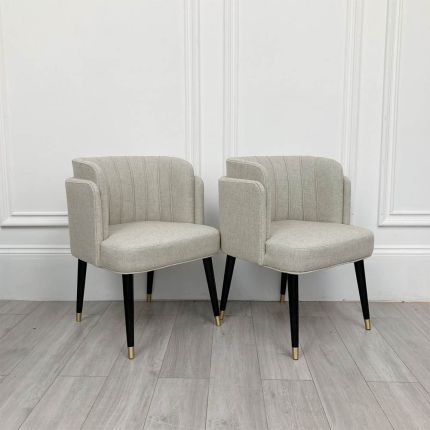 Retro style set of two dining chairs with piping details and linen upholstery 