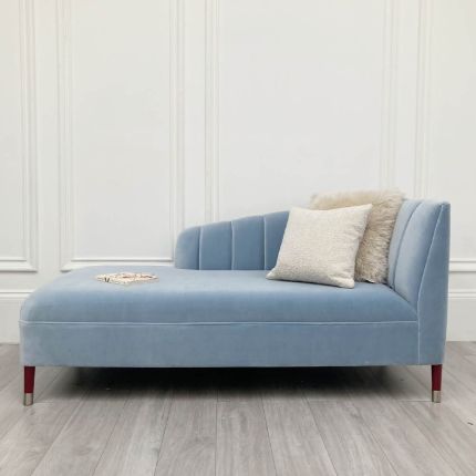 Elegant blue velvet chaise longue with reddish brown feet