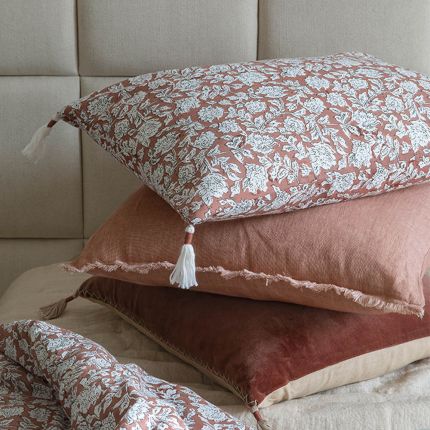 delightful blush cushion with a fringed border