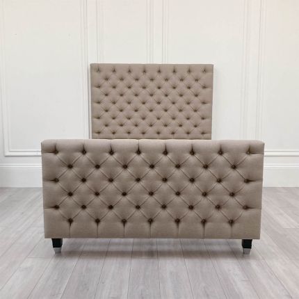 Elegant upholstered bed with studding and deep buttoning
