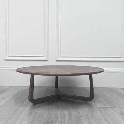 Round brown coffee table with three connected legs