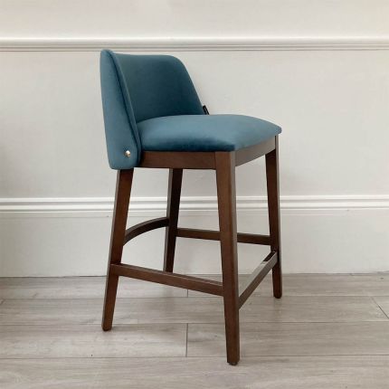 Gorgeous modern counter stool with blue velvet upholstery and dark wood legs