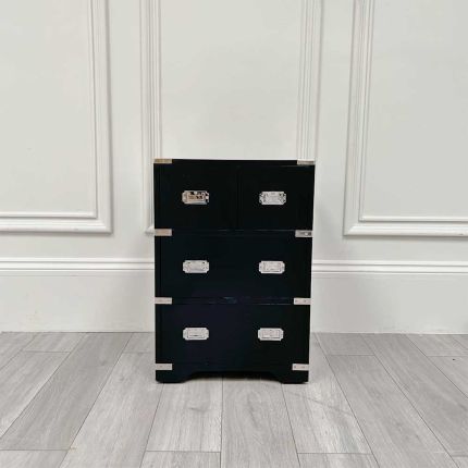 Small black bedside chest with drawers and nickel accents