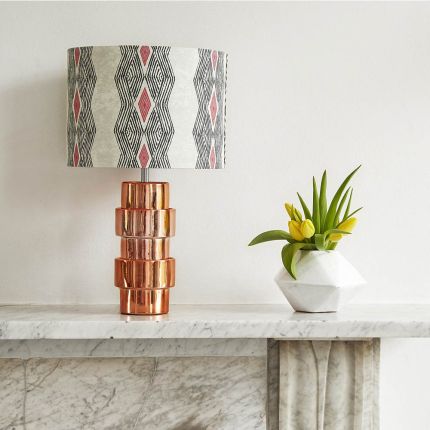 A luxury lampshade by Eva Sonaike with a grey African-inspired pattern