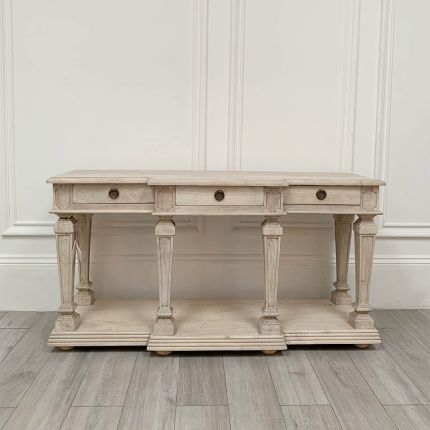 Country style console table with three drawers, column details and a lower shelf