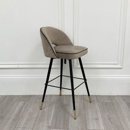 Stylish bar stool upholstered in greige velvet with metal tapered legs 