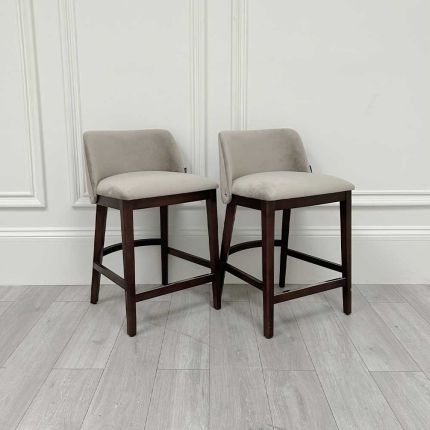 Luxurious counter stools in grey velvet upholstery and complimentary dark brown legs