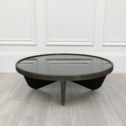 Sleek round coffee table with black glass top and dark wood frame