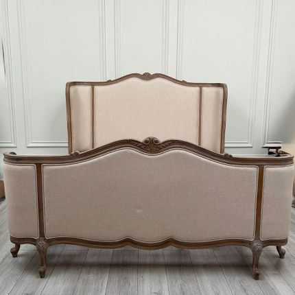 French-style bed with light wooden and linen frame 