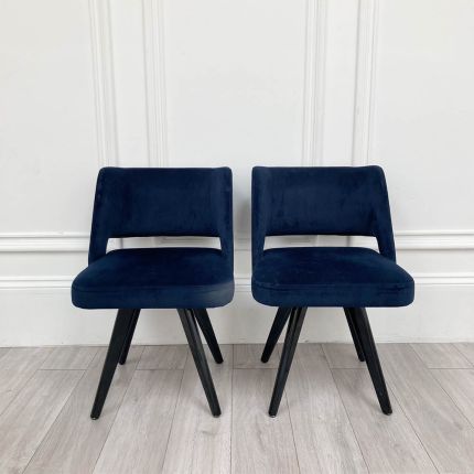 Pair of deep blue velvet dining chairs with gorgeous modern silhouette