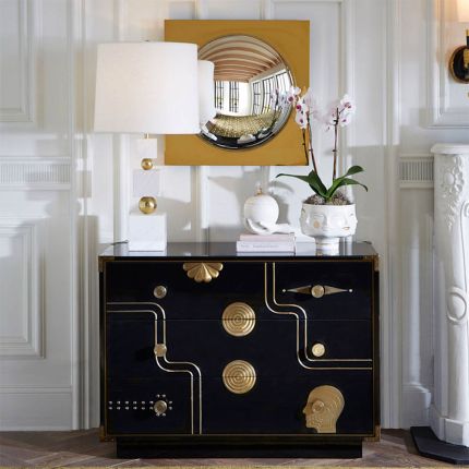 Black three-drawer chest with eclectic gold decorative elements