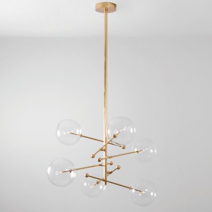 Industrial style 6 arm chandelier in a natural brass finish with 6 clear glass globe bulbs