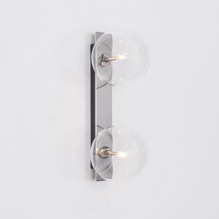 A luxurious double light wall lamp with glass lampshades and a polished nickel