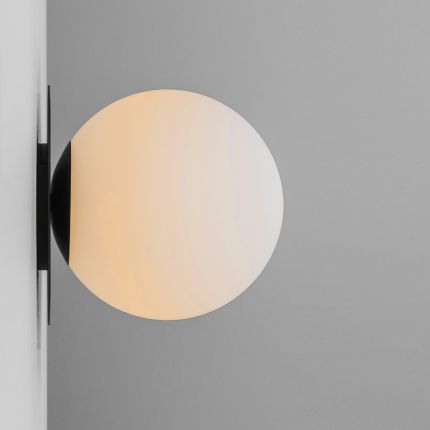A luxury wall lamp by Schwung with a spherical, shade mounted on a black gunmetal plate 