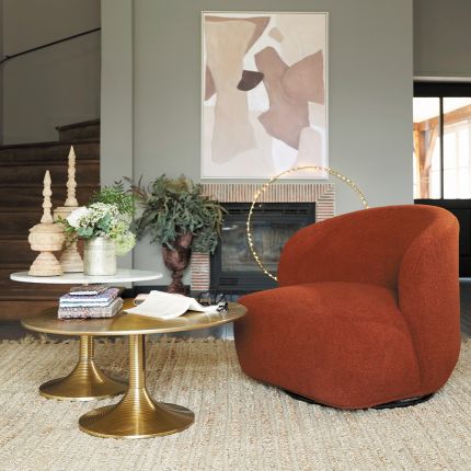 A luxurious armchair with a sumptuous upholstery and stylish swivel base
