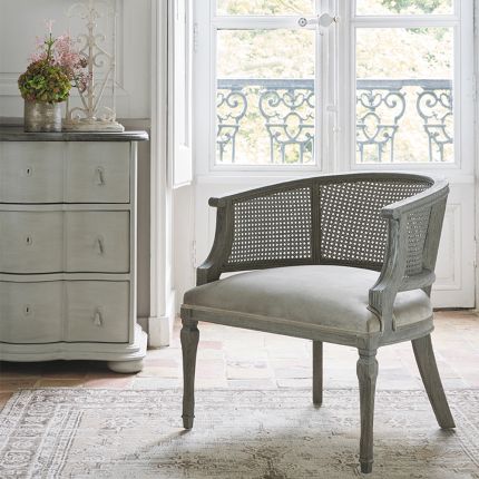 antique grey armchair with caned frame and velvet seat