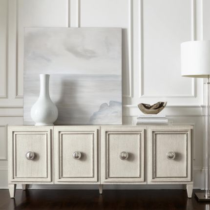 A chic natural wood tv and entertainment unit with 4 doors and metal fixtures