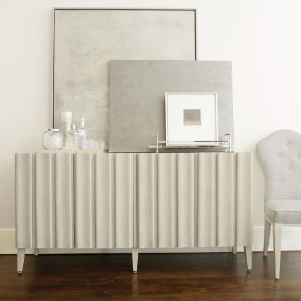 A luxurious four door entertainment unit with a natural finish, stylish shaped vertical overlays and ample internal storage 