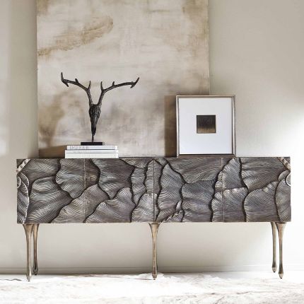 A textured statement sideboard with four unique doors, six sleek metal legs and an abundance of internal storage 