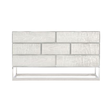 A glamorous dresser from Bernhardt featuring a silver leaf and white lacquer finish with a polished stainless steel frame and seven drawers