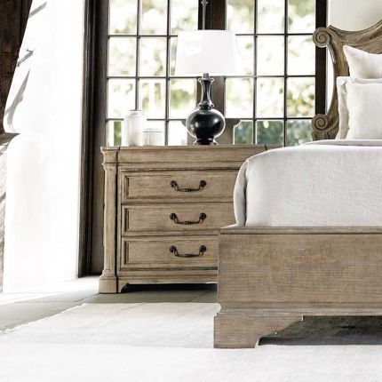 A luxurious wooden bedside table with three drawers.
