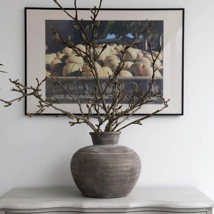 Elegant rounded brown vase with a natural finish