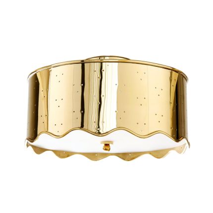 An elegant brass flush mount with a rippled edge and perforated details by Jonathan Adler