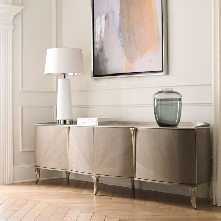 A sophisticated entertainment unit by Caracole with a curved design and elegant feet