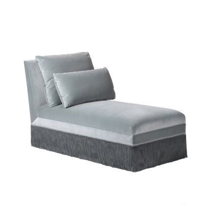 A stunning chaise pholstered in a luxurious blue velvet and decorated with tasselled fringing