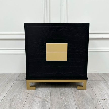 A timelessly elegant black and gold bedside table