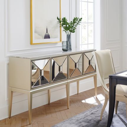 A dazzling sideboard by Caracole with mirrored glass doors and a glamorous gold finish