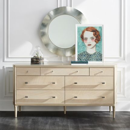 A sophisticated dresser by Caracole with a cream finish, acrylic handles and seven spacious drawers