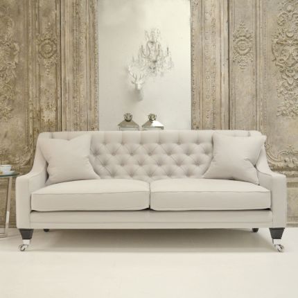 Luxury designer sofa with deep buttoned back and curved arms 