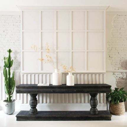 black stained console table with wooden supporting pillars 