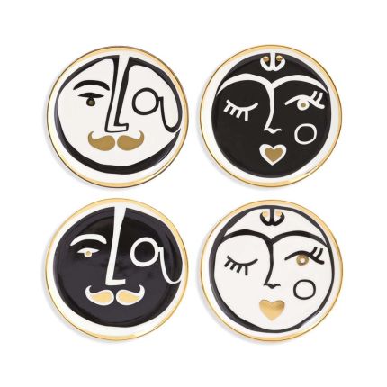 A luxurious set of four porcelain coasters with black, white and gold face designs