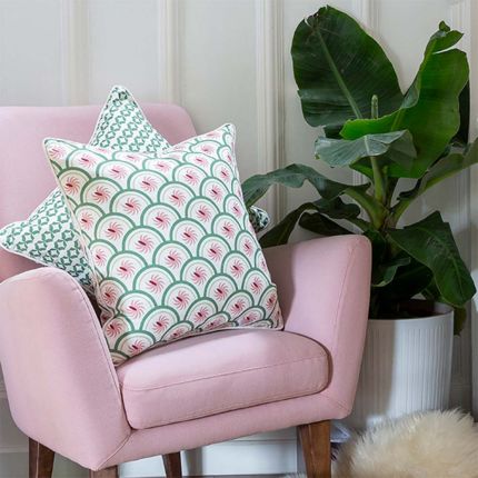 An art deco inspired cushion with green and pink floral details
