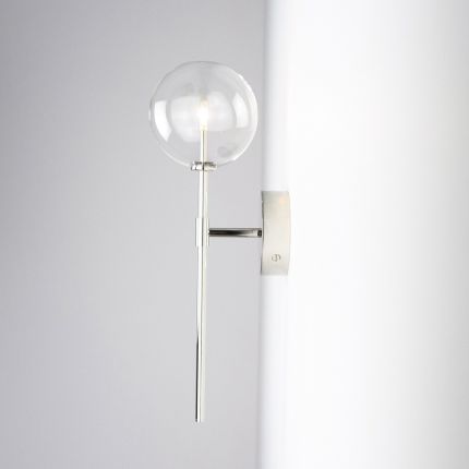 Contemporary industrial wall lamp in polished nickel finish with a large clear glass sphere lampshade