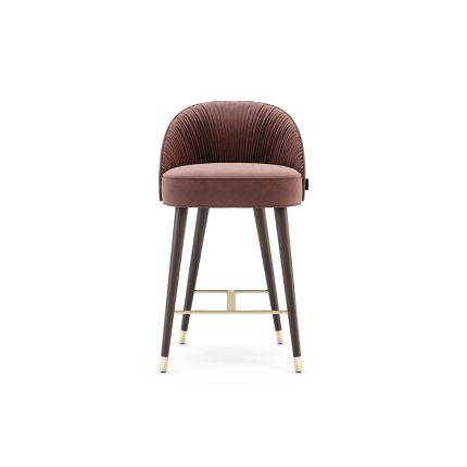 A luxurious counter stool with pleated, velvet upholstery and black wooden legs with golden accents