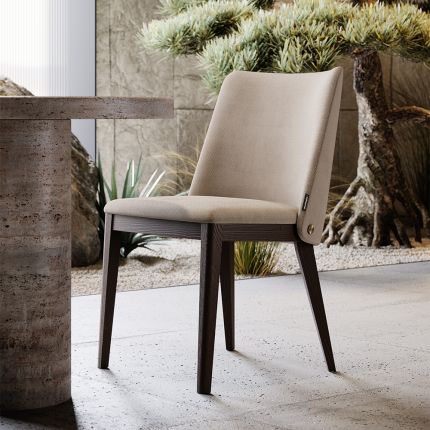 A luxury dining chair by Domkapa with a sophisticated upholstery and opulent wooden legs