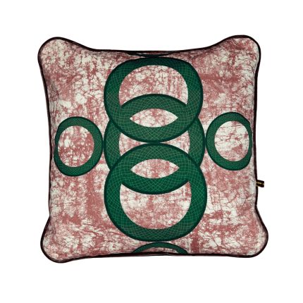 A luxury cushion by Eva Sonaike with a pink and green African-inspired pattern 