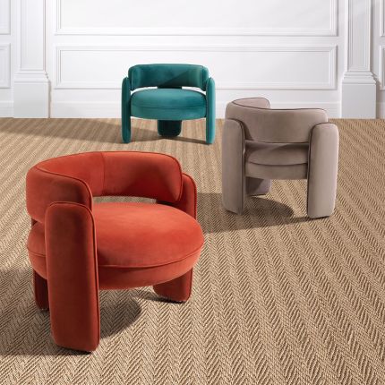 A contemporary armchair with a retro design, luxury velvet upholstery and sophisticated piping