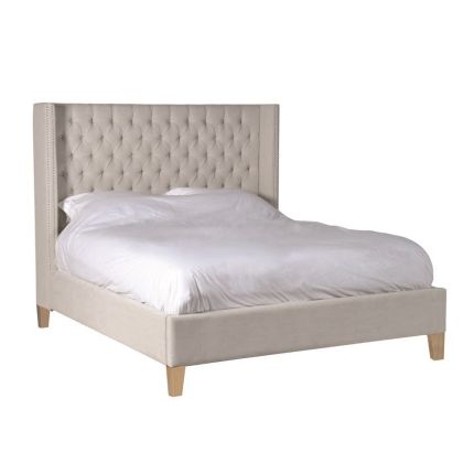 Luxury beige linen kingsize bed with buttoned headboard