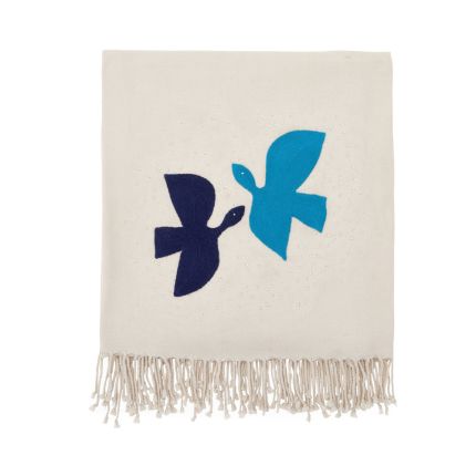 A luxurious ivory throw with blue birds
