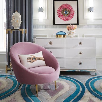 A stylish lavender armchair with polished brass legs