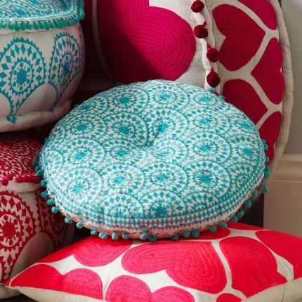 Round embroidered turquoise bohemian patterned cushion