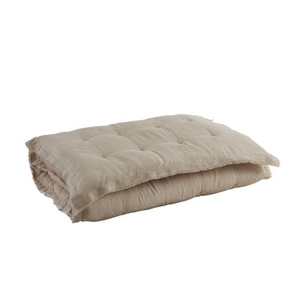 A gorgeous natural-toned quilt with fringed details