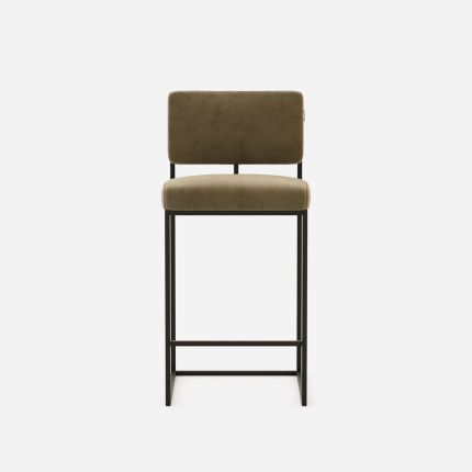 A luxurious modern counter stool with a minimal black metal frame and velvet upholstery