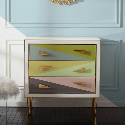 A modern Italian-inspired chest of drawers with angular hardware and brass accents